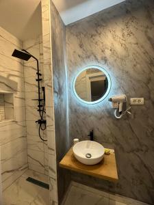 a bathroom with a sink and a mirror at Stay Inn Central Brasov Apartments in Braşov