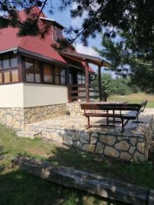 a picnic bench in front of a house at Zeleni Breg in Zlatibor