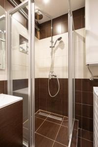 a shower with a glass door in a bathroom at Street'n Apartment in Budapest +26 photos