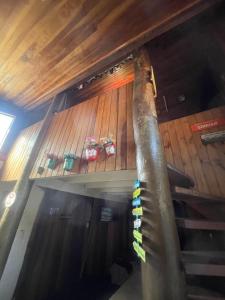 a set of stairs in a room with wooden ceilings at Chale Sabrina in Campos do Jordão
