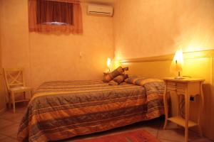 a hotel room with a bed with a teddy bear on it at Casa Vacanze Korello in Gasponi