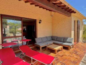 a patio with a couch and chairs and a table at 4AMB2 Villa de caractère avec piscine collective in Collioure