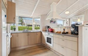a kitchen with wooden cabinets and white appliances at Stunning Home In Esbjerg V With Kitchen in Esbjerg