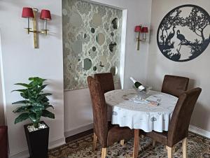 a dining room with a table and chairs and a plant at Estoril Beach in Estoril