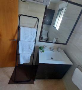 Habitación bonita في سان بييدرو ديل بيناتار: حمام مع حوض ومرآة