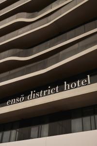 a sign for an eso district hotel on the side of a building at Enso District Hotel in Knokke-Heist