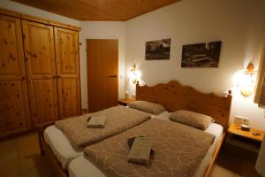 a bedroom with two beds with towels on them at Ferienapartment Candy auf der Gerlitzen in Treffen