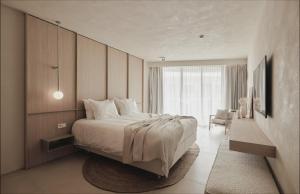 a bedroom with a bed and a large window at Enso District Hotel in Knokke-Heist