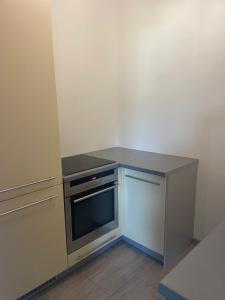 a kitchen with a stove and a counter top at Lawendowy apartament in Mszana Dolna