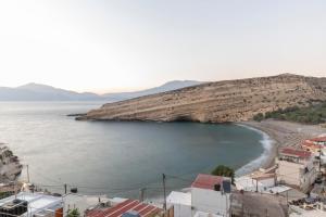 a view of a beach with houses and buildings at Stelios Apartment in Matala