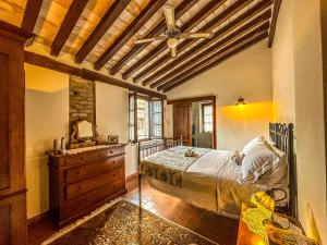 a bedroom with a bed and a dresser and a ceiling at Agriturismo Dandelion in Città della Pieve