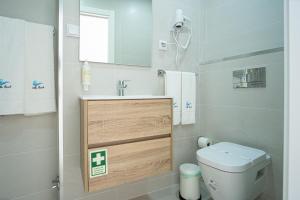 a small bathroom with a toilet and a sink at Villa Beach in Nazaré