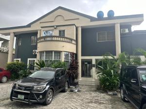 a black car parked in front of a house at Primal Msquare Apartment Ikoyi in Lagos