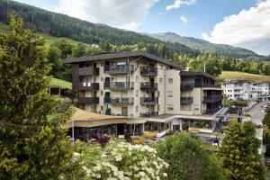 a large apartment building in the middle of a town at Vinumhotel Feldthurnerhof in Feldthurns