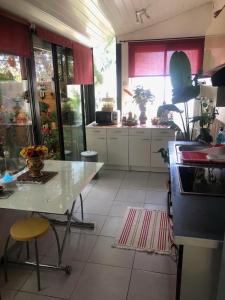 a kitchen with a counter and a table in it at Dépendance de 30m² dans maison avec entrée privée in Six-Fours-les-Plages