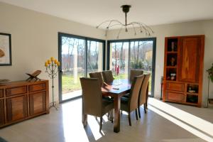 a dining room with a table and chairs at Coteaux De Braules in Gindou