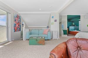 a living room with a couch and a bed at Arcadia Beachfront Retreat in Mandurah
