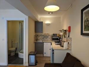 a small kitchen with a sink and a toilet at The Ramblers' Rest - Princetown in Princetown