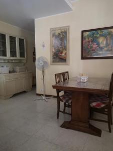 a kitchen with a table and chairs and a fan at Casa Rovere Perugia in Perugia