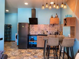 a kitchen with a table and a refrigerator at Barney's apartment in Batumi