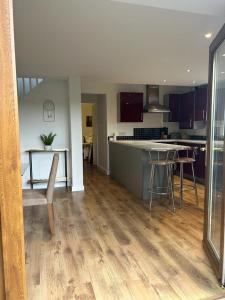 a kitchen with a table and a counter top at Pine Lodge - Two Bedrooms, High Bickington close to Umberleigh , Barnstaple , Bideford in High Bickington