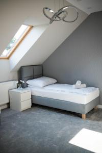 a bedroom with a bed in a attic at Apartamenty Wielbarska in Szczytno
