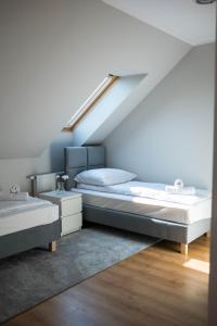 a bedroom with a bed and a staircase at Apartamenty Wielbarska in Szczytno
