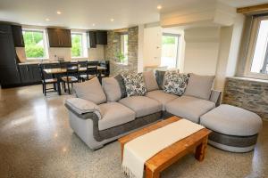 a living room with a couch and a table at Killarney Old School Road sleeps 6 in Killarney