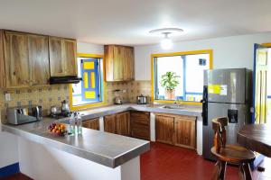 a kitchen with wooden cabinets and a stainless steel refrigerator at San Antonio in Quimbaya