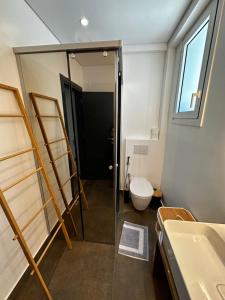 a bathroom with a shower and a toilet and a sink at Rustemi in Sarandë