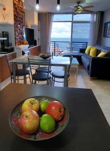 a bowl of apples on a table in a living room at Balcón Atlantida in Candelaria