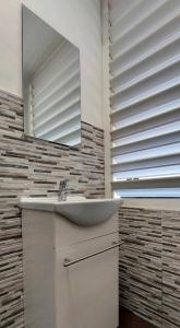 a bathroom with a sink and a mirror at Balcón Atlantida in Candelaria