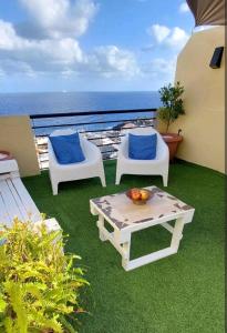 a balcony with a table and two chairs and the ocean at Balcón Atlantida in Candelaria