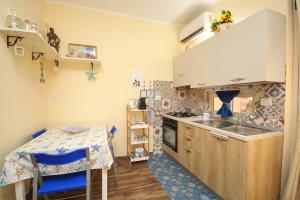 a small kitchen with a table and a sink at La casa di Jack in Bagheria