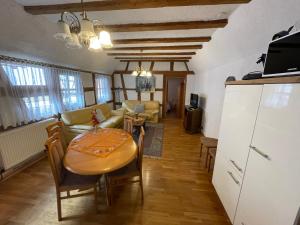 a kitchen and living room with a table and a couch at Weingut und Destillerie Bernd Klein in Pleisweiler-Oberhofen