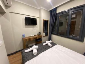 a bedroom with a bed with white towels on it at Zeyn Otel Istanbul in Istanbul