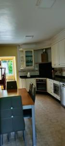 a kitchen with a wooden table with chairs and a table and a table at Eido Benito in Mondariz