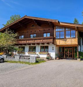 a large wooden house with a lot of windows at Landhaus Aaron in Altenmarkt im Pongau