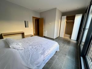 ein Schlafzimmer mit einem weißen Bett und einem Fenster in der Unterkunft Nou allotjament rural: Cal Teca in Sant Antolí i Vilanova