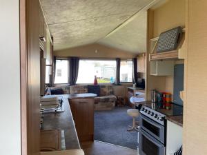 a kitchen and living room of an rv at Peaceful holiday home on a park on the Kent Coast in St Margarets at Cliff