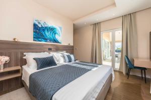 a bedroom with a large bed and a desk at Exclusive luxury Villa with glorious sea view - by TA Leut Agency in Privlaka +42 photos