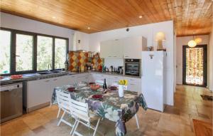 una cucina con tavolo e frigorifero di Stunning Home In Montbrison Sur Lez With Kitchen a Montbrison-sur-Lez