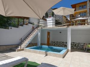 a house with a swimming pool next to a staircase at Casa Anca in Băile Herculane