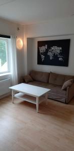 a living room with a couch and a coffee table at Hällevadsholm in Hällevadsholm