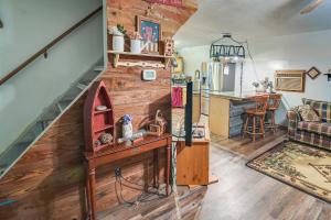 a living room with a staircase and a kitchen at Cozy Country Cabin 4 Mi to Cave Run Lake! in Wellington