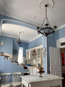 a kitchen with a table and a chandelier at Vila Aurora in Luso