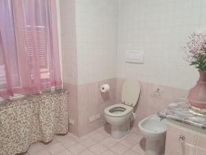 a bathroom with a toilet and a vase on a counter at LA CASA DI MINA in Vernazza +23 photos