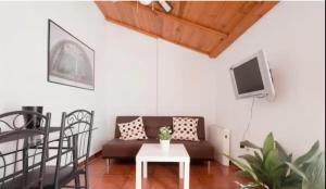 a living room with a couch and a table at Apartamentos centro historico a los pies de la Alhambra in Granada