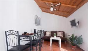 a dining room with a table and chairs and a tv at Apartamentos centro historico a los pies de la Alhambra in Granada