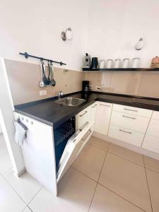 a kitchen with a sink and a counter top at Villa Pearl - Steps from the Sea in Kralendijk